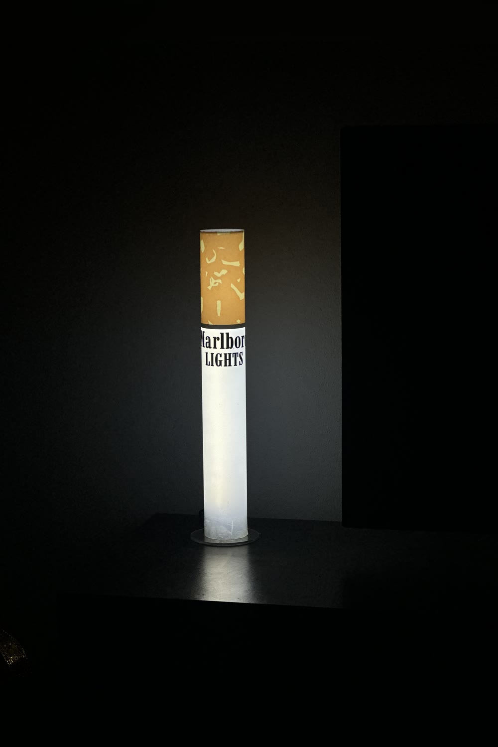 Giant cigarette-shaped floor lamp as man cave decor